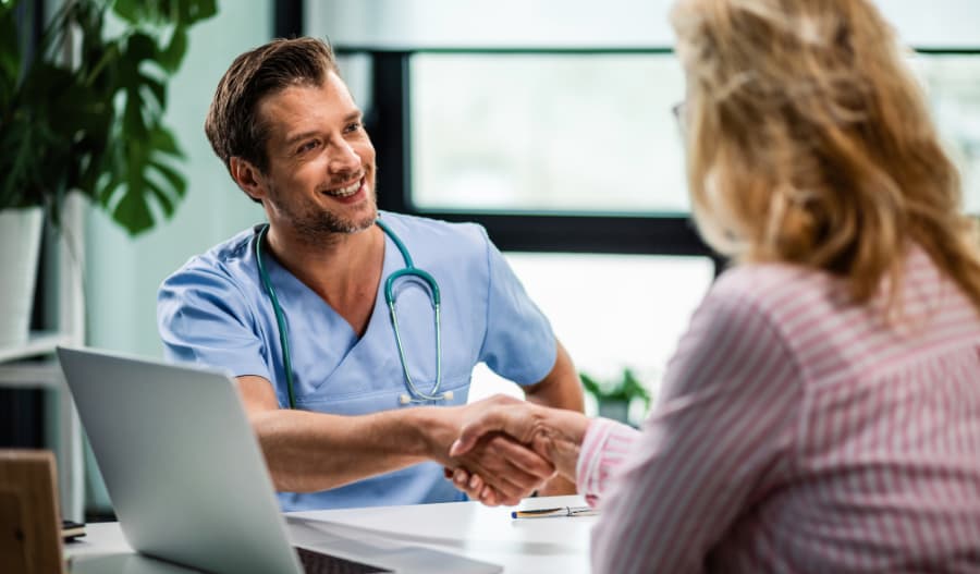 Healthcare CRM Solution - A doctor shaking patient's hand 