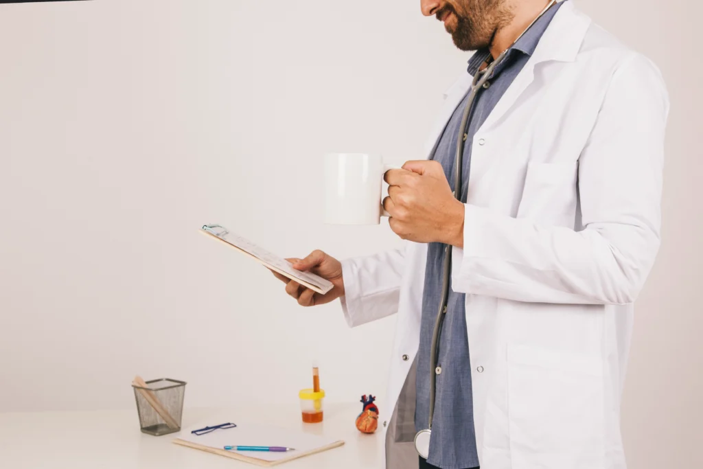 doctor drinking coffee working with ipad